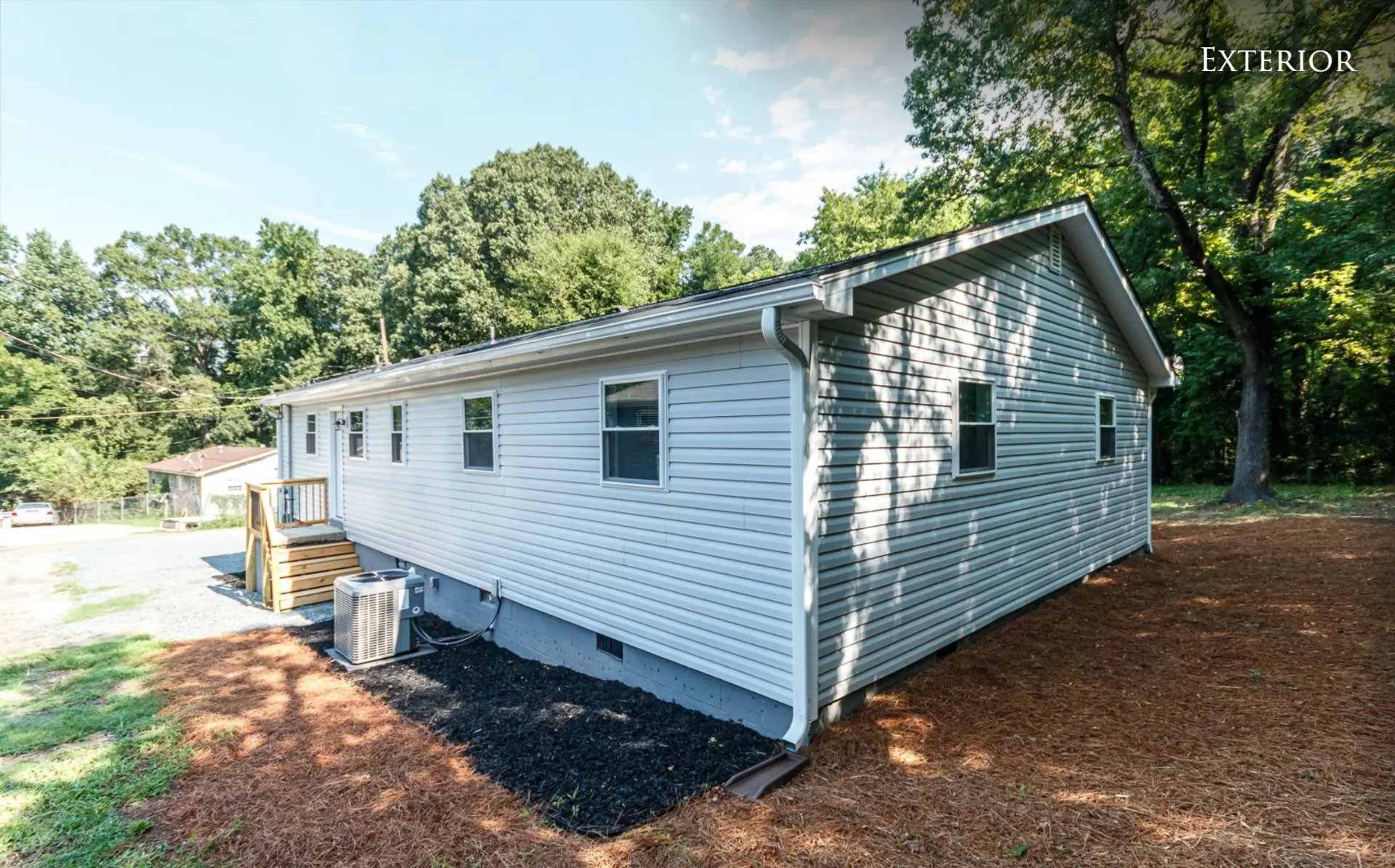 Rear and side of the duplex with mature trees