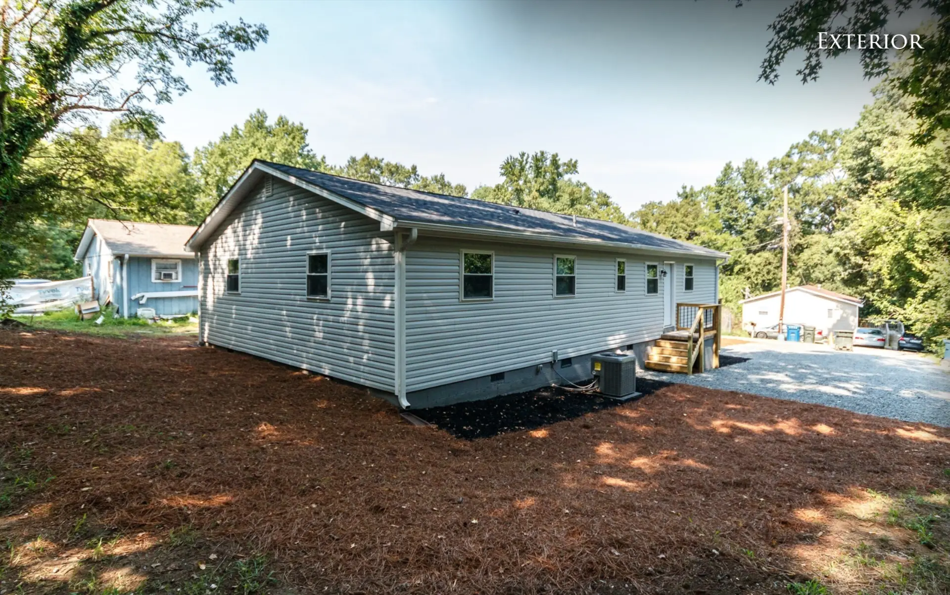 Back of the duplex and gravel parking area