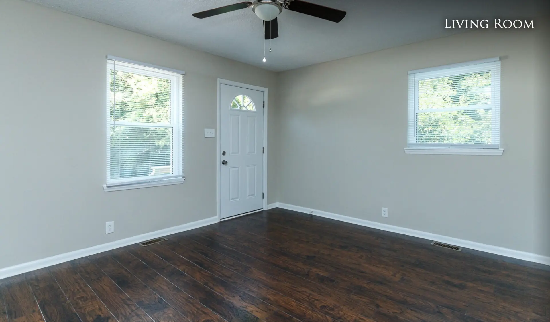 Unit A living room with front door and ceiling fan