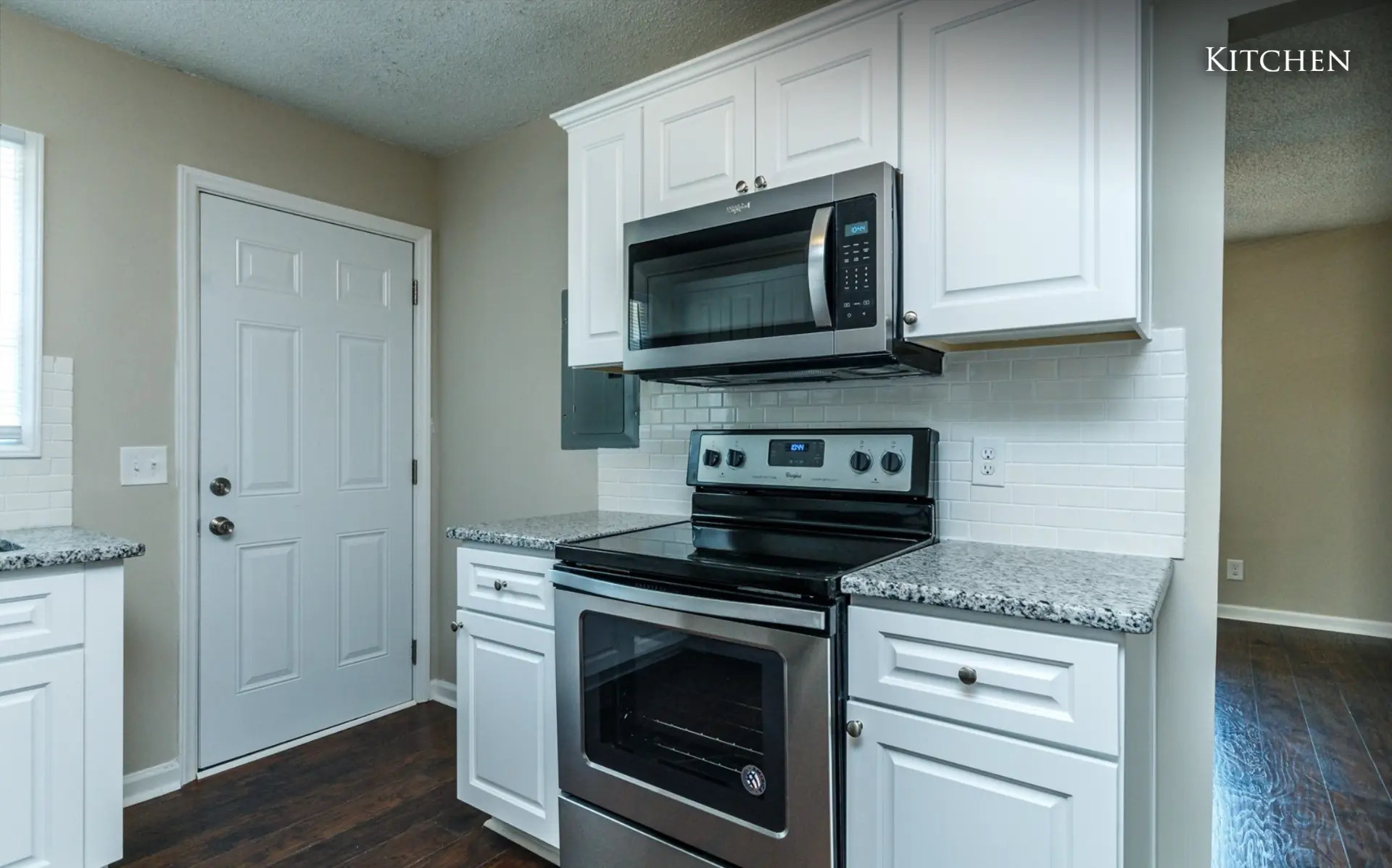 Unit B kitchen range, microwave and back door