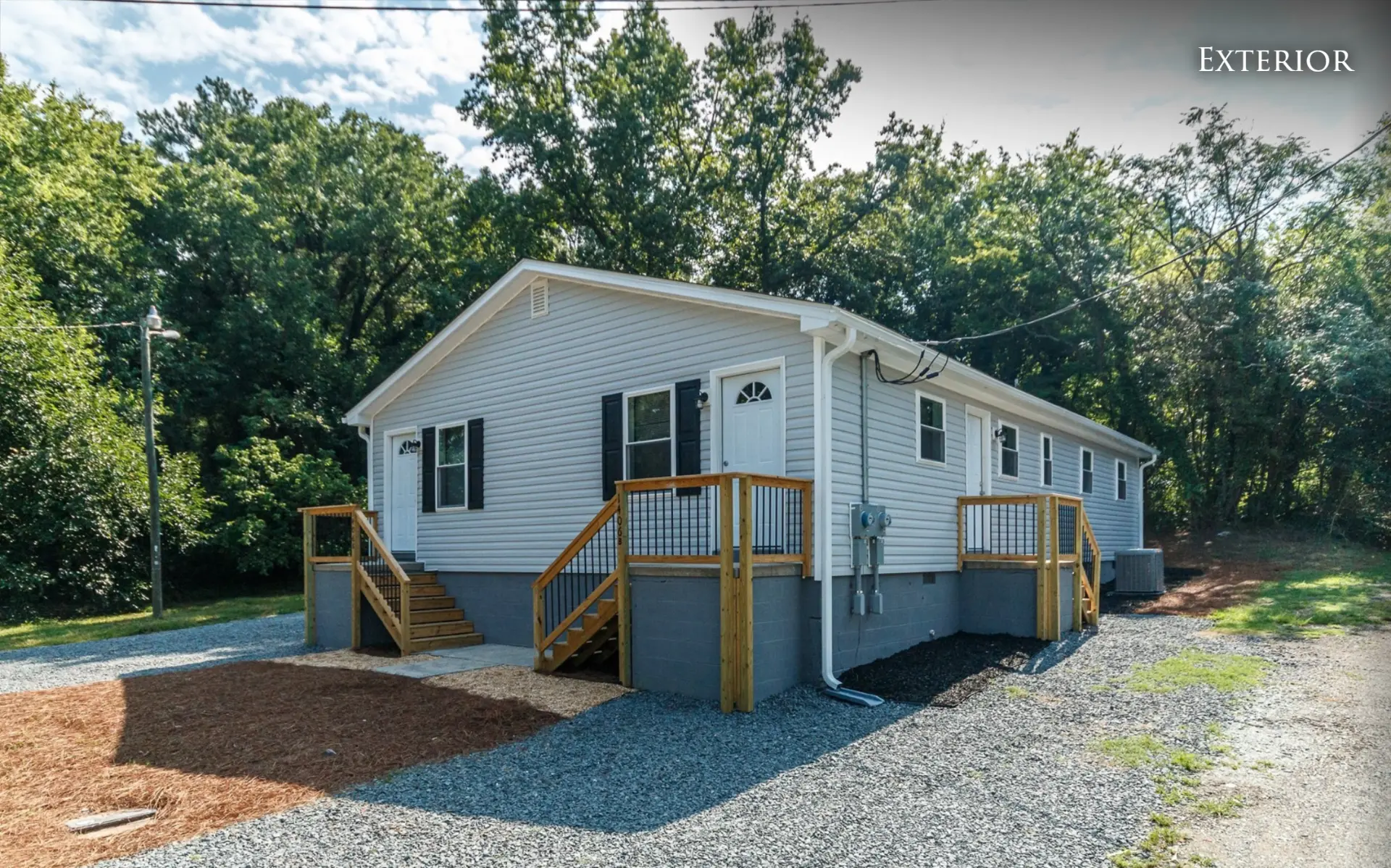 Front corner of the duplex showing both entry decks